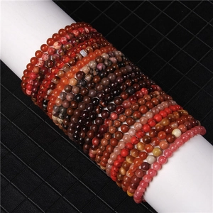 Detail shot of 6mm natural red agate and assorted crystal gemstone stretch bracelets