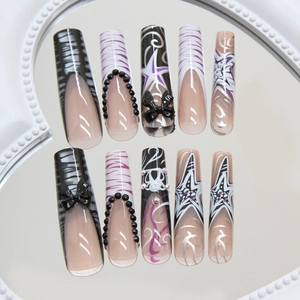 Long ballerina press-on nails with black bow, zebra stripes and rhinestones
