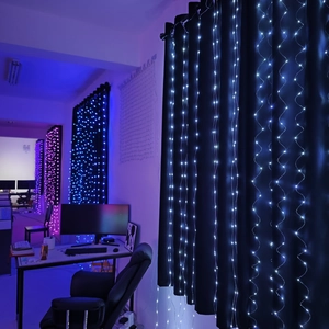 Close-up of LED curtain lights showing white, blue and purple lighting effects on curtains