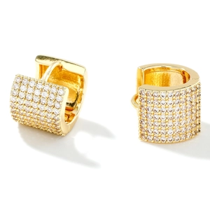 Luxurious gold huggie hoop earrings with micro-pave cubic zirconia stones on white background