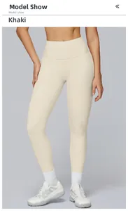 Detail view of khaki high waisted yoga leggings showing stretch fit on a model