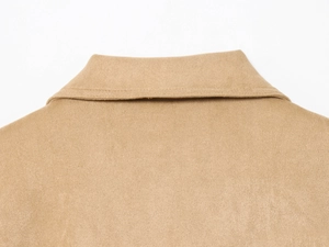 Close-up of lapel collar on tan suede jacket showing fine stitching and soft texture