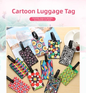 Detail of colorful PVC luggage tags with diverse patterns on a light wooden background
