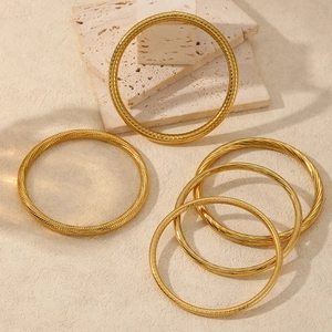 Minimalist gold-plated stainless steel hollow bangle bracelets with textured spiral design