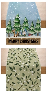 Detail of Christmas table runners with festive reindeer, gnome prints and mistletoe patterns