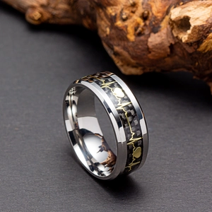 Macro detail of 8mm steel ring with black carbon fiber inlay and golden heartbeat pattern