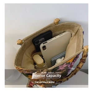 Internal capacity of linen tote with floral embroidery and natural bamboo handle