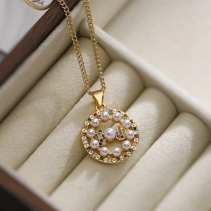 18K gold plated necklace with round pendant featuring colorful gems and pearls in a box