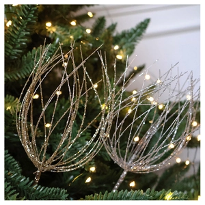 Close-up of sparkling gold and silver glitter Christmas tree floral branch picks