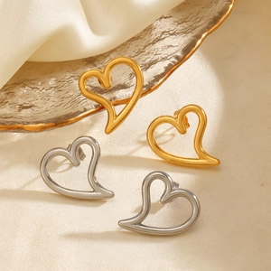 Hollow heart stud earrings in gold and silver stainless steel finish set on silk
