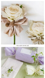 Vertical detail of floral wrapping paper with white roses and candy-style gift packaging