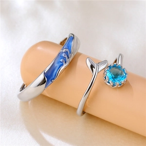 Adjustable silver fishtail couple rings set with blue enamel waves and zircon stones