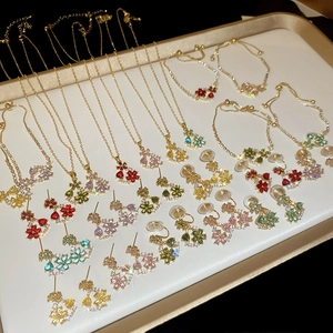 Detailed view of 18k gold plated jewelry set with colorful floral rhinestone charms