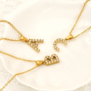 Golden cubic alphabet necklace with A, B, C pendants and shimmering white zircon stones
