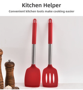 Close-up of red silicone spatula and slotted turner with stainless steel handles for cooking