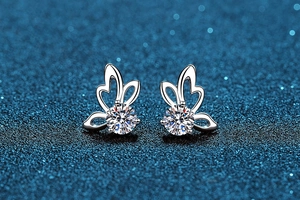 Macro detail of butterfly sterling silver stud earrings with sparkling round moissanite