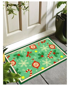 Detail of Christmas doormat with holly, candy canes, and stars on green background