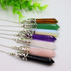 Detailed view of hexagonal crystal bullet pendants in various natural stone colors