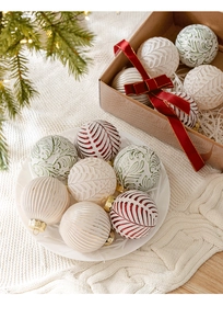 Macro shot of 8cm white Christmas balls with red and green patterns in festive decor