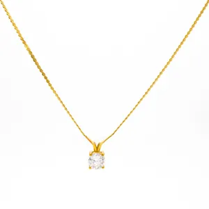 Detailed view of simple gold-plated necklace with a classic round cubic zirconia pendant