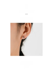 Minimalist 925 sterling silver round stud earrings with light blue enamel on ear