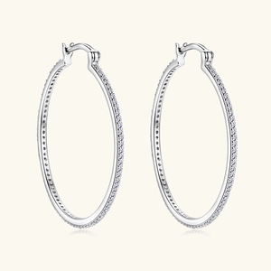 Macro detail of large sterling silver hoop earrings with pave-set shimmering zircon stones