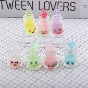 Detailed view of colorful miniature resin bottles with heart straws on acrylic ice cubes