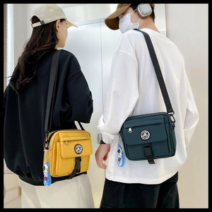 Japanese techwear crossbody bag in yellow and dark green with astronaut pendant