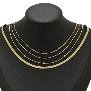 Gold multi-layer snake bone and bead choker necklace set on a black neck model