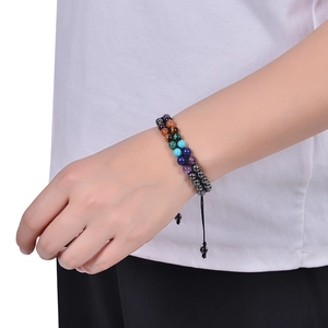 Detail of double-layer woven stone bracelet with natural beads and adjustable black cord