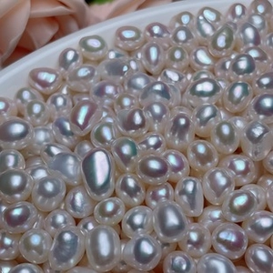 Macro view of high luster white baroque pearls with natural iridescent glow and textures