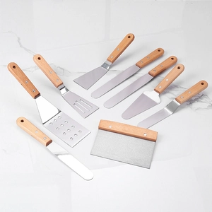 Set of 8 stainless steel baking tools with wooden handles on marble surface
