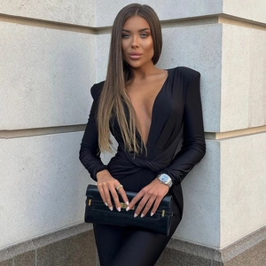 Detail of sexy deep V-neck black bodysuit with shoulder pads and waist knot detail