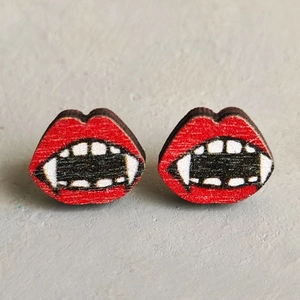 Spooky red vampire lips and white fangs Halloween stud earrings on gray background