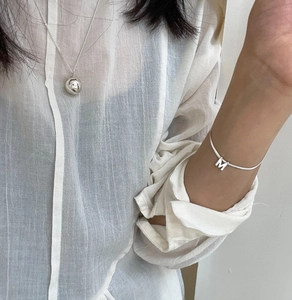 Minimalist 925 sterling silver ball necklace and letter M charm bracelet on model