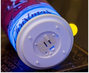Macro detail of Christmas LED candle base showing ON/OFF switch and battery compartment