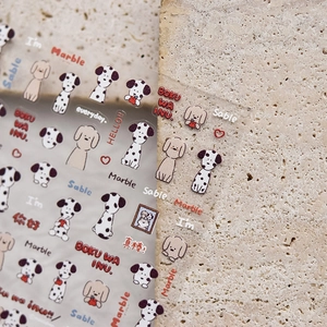 Detail of cute dog stickers on stone surface showing transparent material for DIY decor