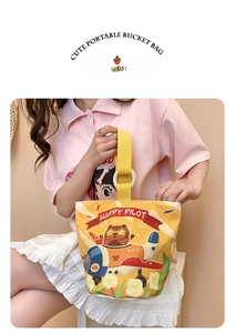 Cute yellow canvas bucket bag with cat pilot print and wooden ring handle detail
