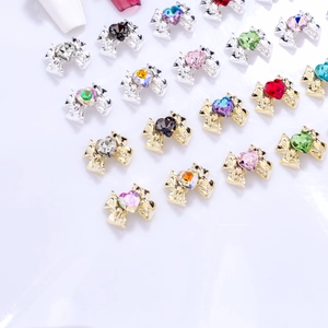 Mix of alloy bowknot nail art charms with heart-shaped rhinestones in gold and silver