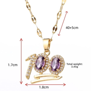 Macro detail of a 100 emoji gold necklace with purple gems and white crystals