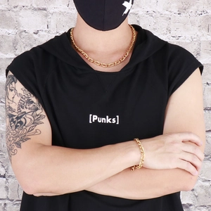 Close-up of golden Figaro chain necklace and bracelet set worn by a male model