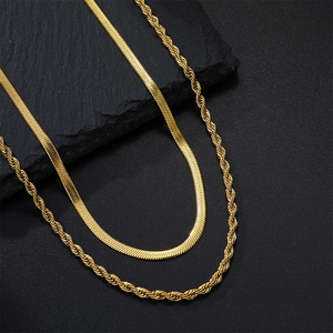 Detail view of double-layered 18k gold plated snake and twist rope chain necklaces