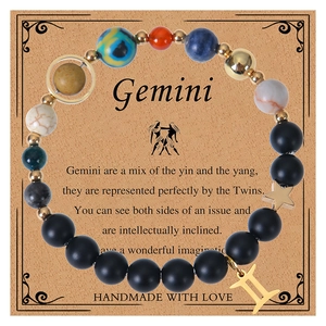 Gemini zodiac bracelet with black volcanic beads and star charm on gift card