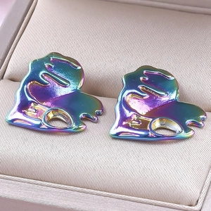 Macro shot of liquid metal heart earrings with iridescent finish in a jewelry box
