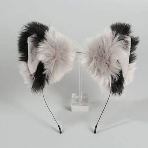Detailed view of handmade plush black and white faux fur cat ears on a headband