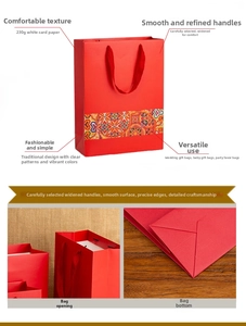 Detail view of red Chinese style gift bag with wide ribbon handles and vintage floral pattern