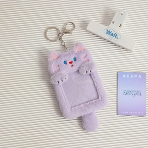 Detail of purple plush cat photocard holder with metal keychain and transparent window