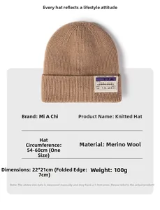 Close-up of brown knit beanie showing soft sheep cashmere texture and fabric patch detail