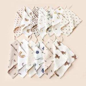 Set of 13 soft cotton muslin baby washcloths featuring various prints and hanging loops