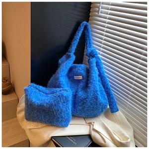 Close-up of fluffy electric blue wool tote bag showing soft texture and shoulder strap